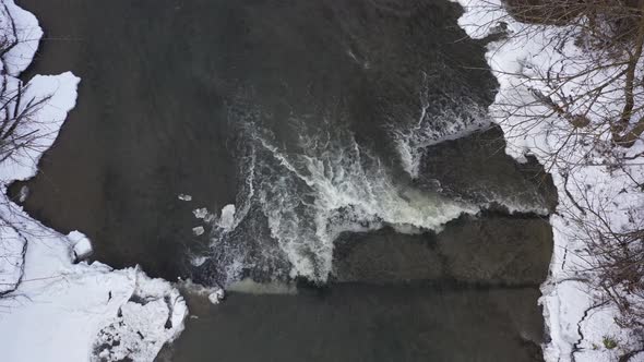 icy winter river mini waterfall overhead static view