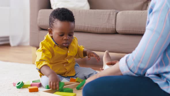 Mother and Baby Playing with Toy Blocks at Home 16