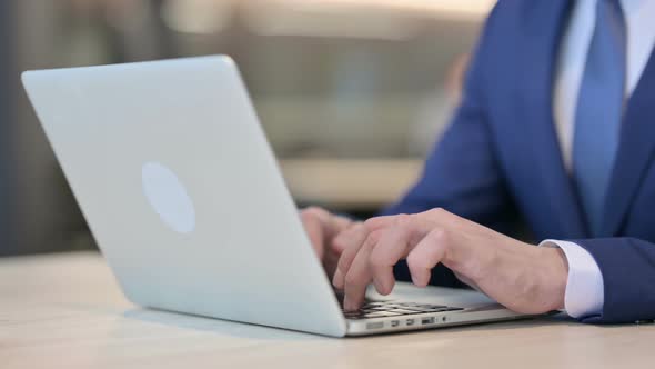 Close Up of Businessman Working on Laptop