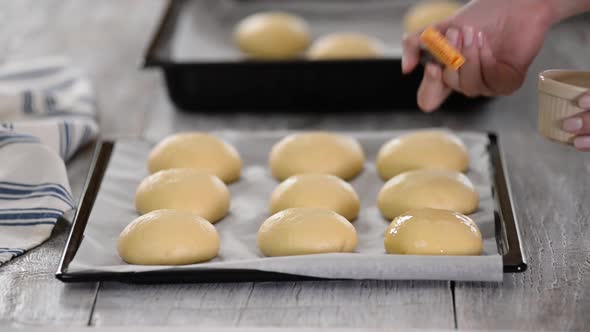 Smearing Raw Buns With Brush In Yolk.