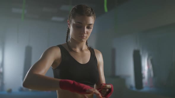 Woman Fighter Wraps Her Hands with Boxing Bandages Kickboxing Training Day in a Gym Female Fighter