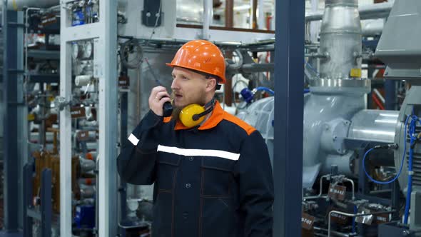 An Oil and Gas Industry Worker Stands in a Gas Compression Shop