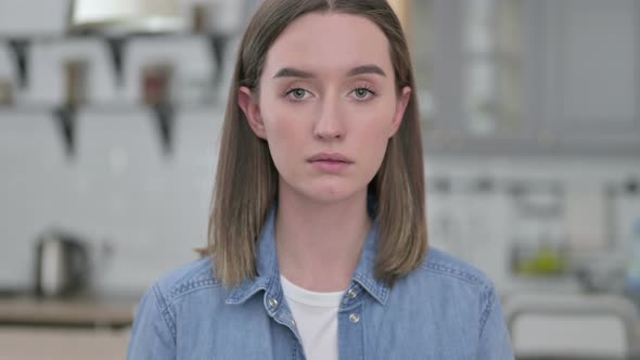 Portrait of Serious Young Woman Looking at the Camera