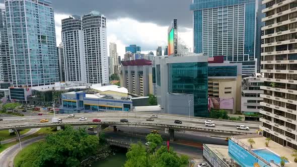 Aerial drone footage in downtown Panama City with highway in front of buildings