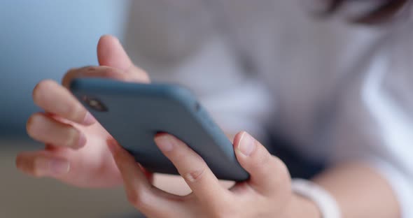 Close up of woman use of mobile phone at home