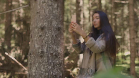 Woman Recording Vlog Video on Phone Outdoors in Forest