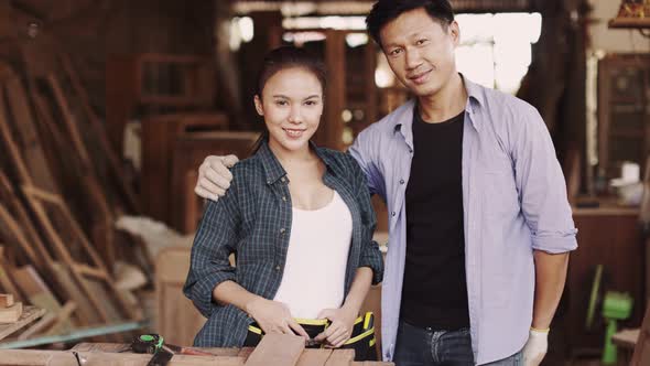 Two asian carpenters in a construction workshop. business man and woman working together