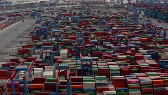 Aerial View of Multiple Automated Industrial Cranes Moving Large Cargo Containers in Hamburg Port