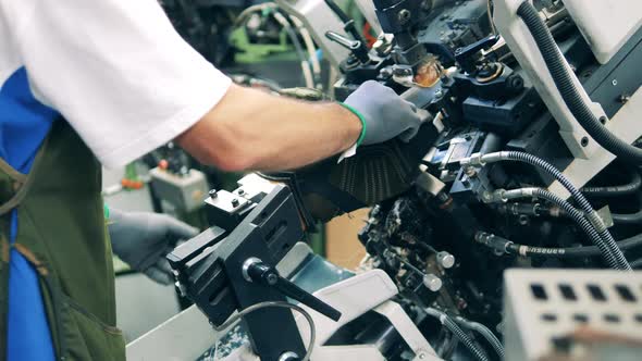 Factory Employee Is Loading a Boot Into an Adjustment Mechanism