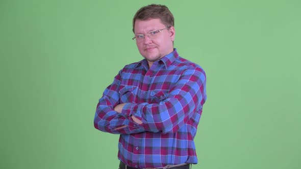 Happy Overweight Bearded Hipster Man Smiling with Arms Crossed