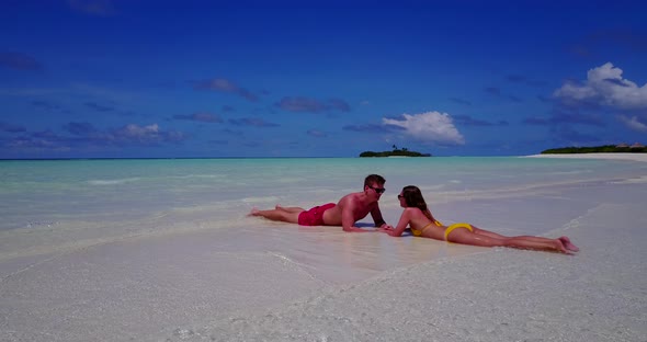 Romantic boy and girl in love dating on vacation spend quality time on beach on white sand 