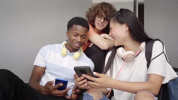 Group of Adolescent Students of Different Ethnicities Using Cell Phones