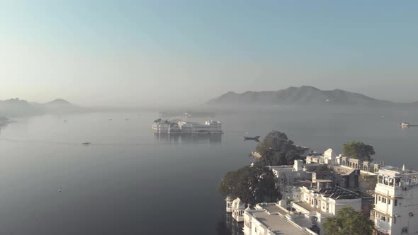 Taj Lake Palace in the middle of the lake Pichola, viewed from Ambrai Ghat in Udaipur, India