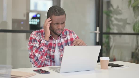 African Man Having Headache While Working on Laptop