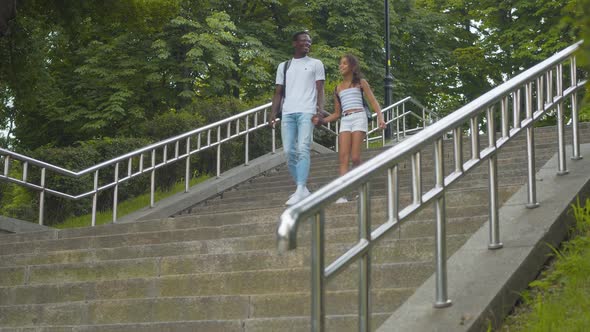 Happy African American Brother and Sister Walking Down the Stairs in Park and Leaving. Portrait of