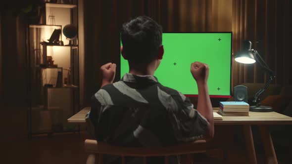 Asian Boy Student Celebrating With Mock Up Computer Green Screen At Home, Learning Online