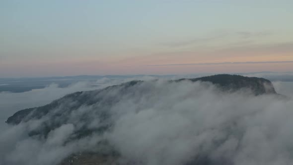 Sunrise overlooking Mount Kineo capped with thick fog, Aerial shot