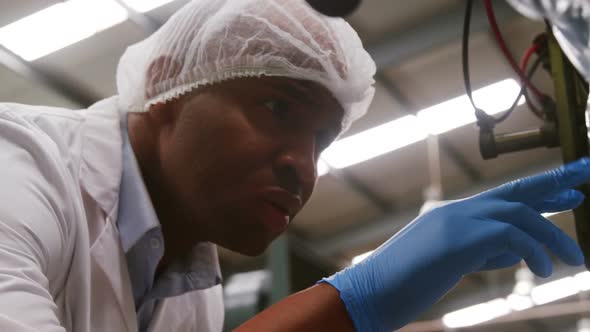 Attentive worker examining a bottle