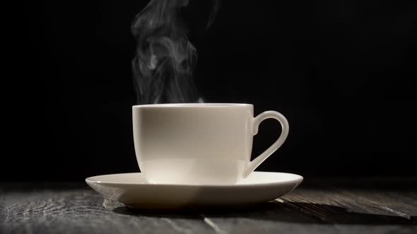 Steaming Coffee Cup on Dark Wooden Background