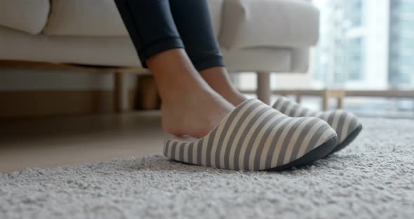 Woman wear slipper at home