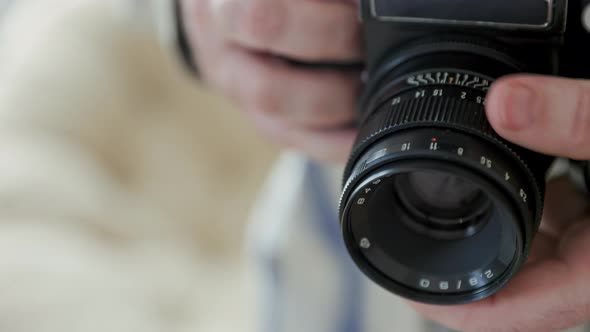 Close-up vintage photo camera details, setting up the film camera.