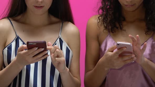 Cheerful Women Watching Photos on Smartphones