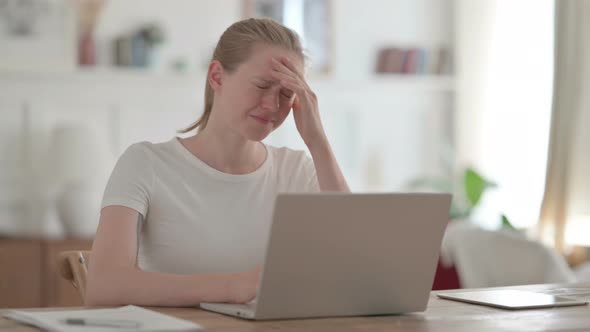 Beautiful Young Woman Having Headache While Working on Laptop