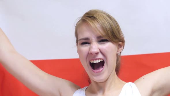 Polish Young Woman Celebrating While Holding the Flag of Poland in Slow Motion