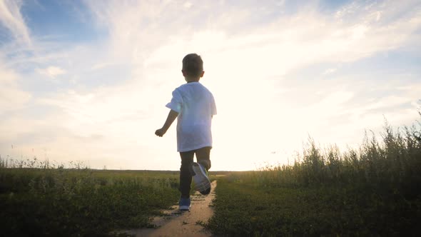 Cheerful Kid on the Road at Sunset