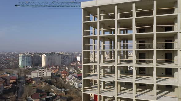 Aerial view of city residential area with high monolithic apartment building under construction 