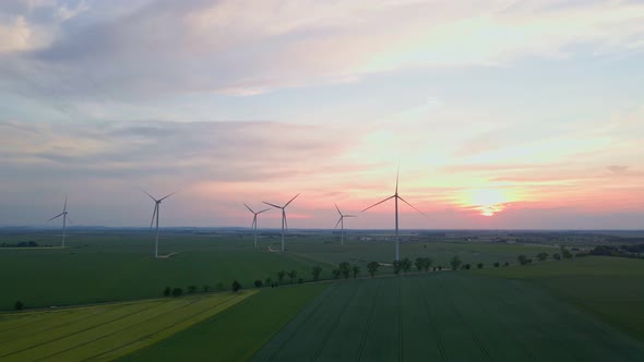 Windmill Turbines at Sunset Wind Energy Concept