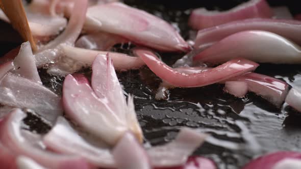 Cooking chopped red onion on non stick fry pan. Slow Motion.