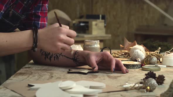 Young Hipster Painting Handmade Goods in her Studio