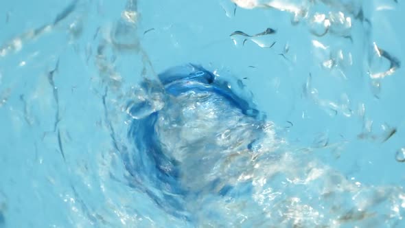 Closeup Water Falling Down From Bottle with Drops Splashing Super Slow Motion