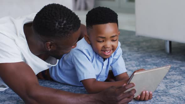 African american father and son using a digital tablet together