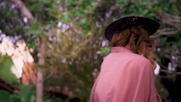 Young Red Haired Woman in Pink Kimono Whirls in a Dance on Tropical Paradise