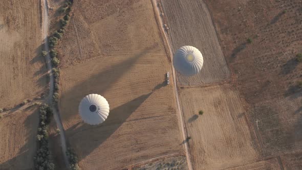 White Tourist Hot Air Balloons Prepared to Flight on Field