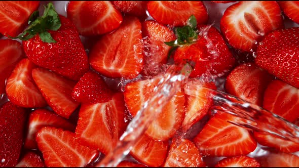 Super Slow Motion Shot of Splashing Water To Fresh Strawberries at 1000Fps.