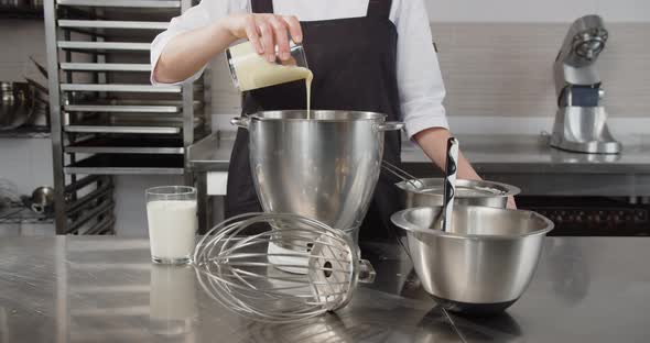 The Chef Adds Various Ingredients to the Cooking Vessel