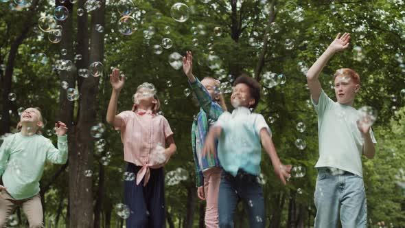 Children with Soap Bubbles Outdoors