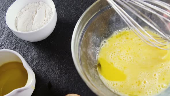 Woman whisking egg in bowl 4k