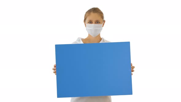 Beautiful Businesswoman in Protection Mask Holding Blank Board on White Background