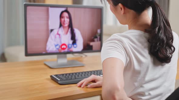 Asian woman worker consult with online virtual telemedicine doctor for medical health care in house.