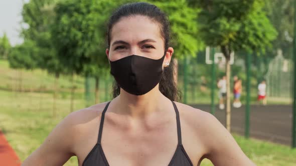 Female Jogger with a Medical Mask on the Face