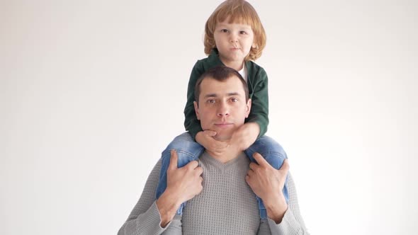 Son Sits on Father's Shoulders Happy Family Love Tenderness and Care