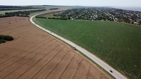 Aerial View of Highway Road Between Meadow and Agricultural Field