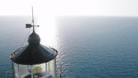 Close up view of top of lighthouse at sunset.
