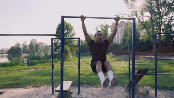 Outdoor Gym with African Man Doing Pull Up on Horizontal Bar