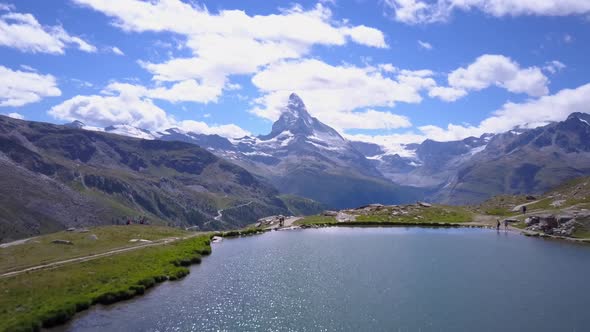 Aerial travel drone view of Zermatt at the Stellisee Lake, Mount Matterhorn, Switzerland.