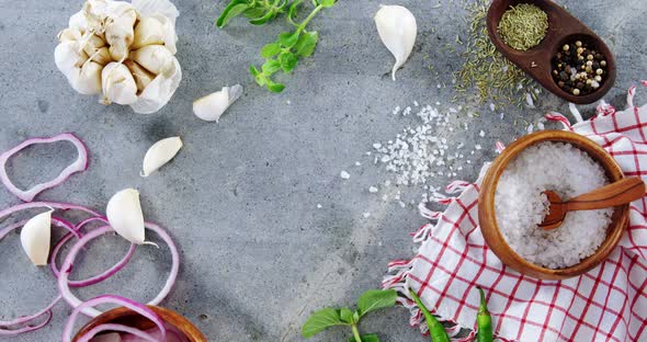 Various spices and ingredients on concrete background